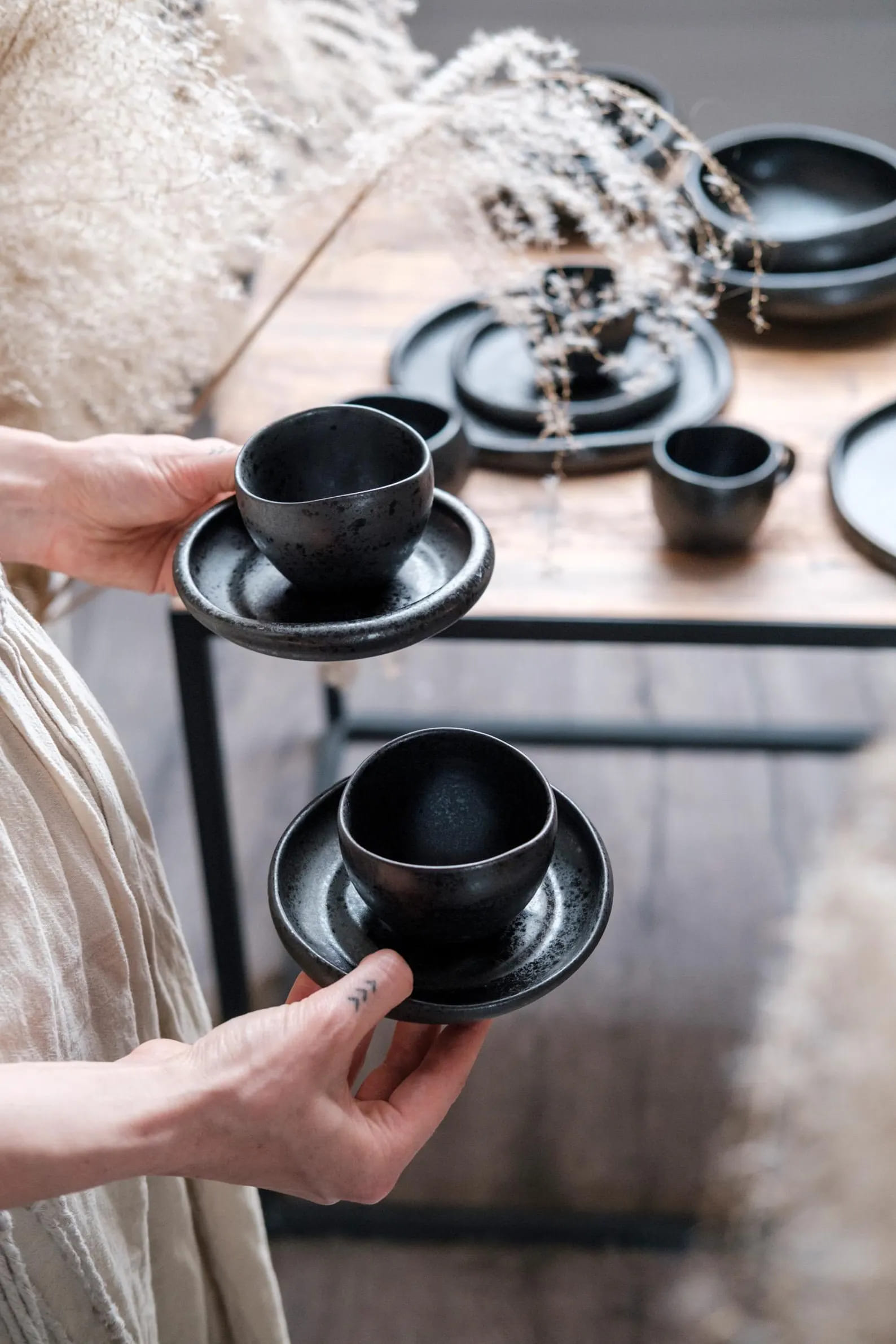 Black speckled ceramic vessels and bowls in different sizes