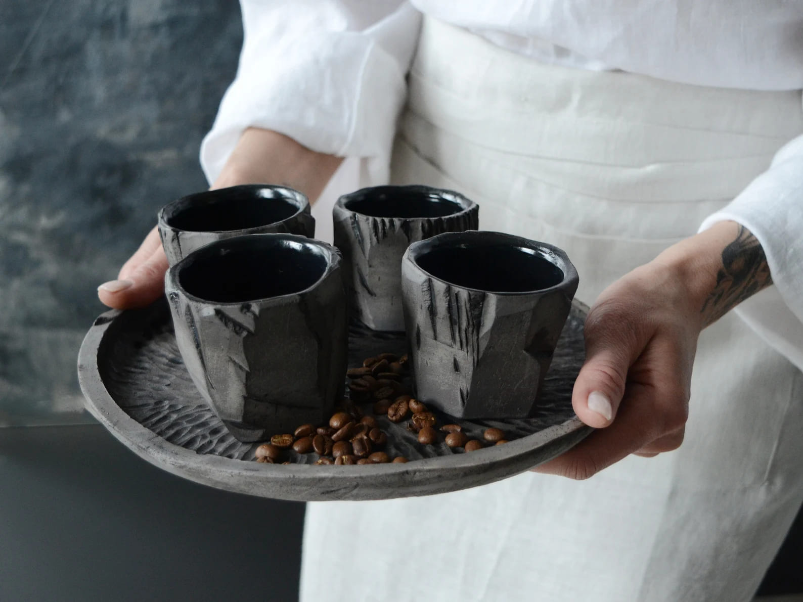 Two black tea bowls stacked on a decorative runner